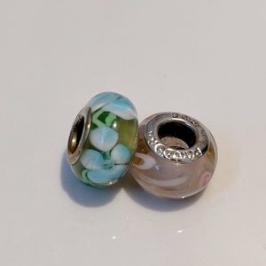 One Pandora and one Morano glass charm.